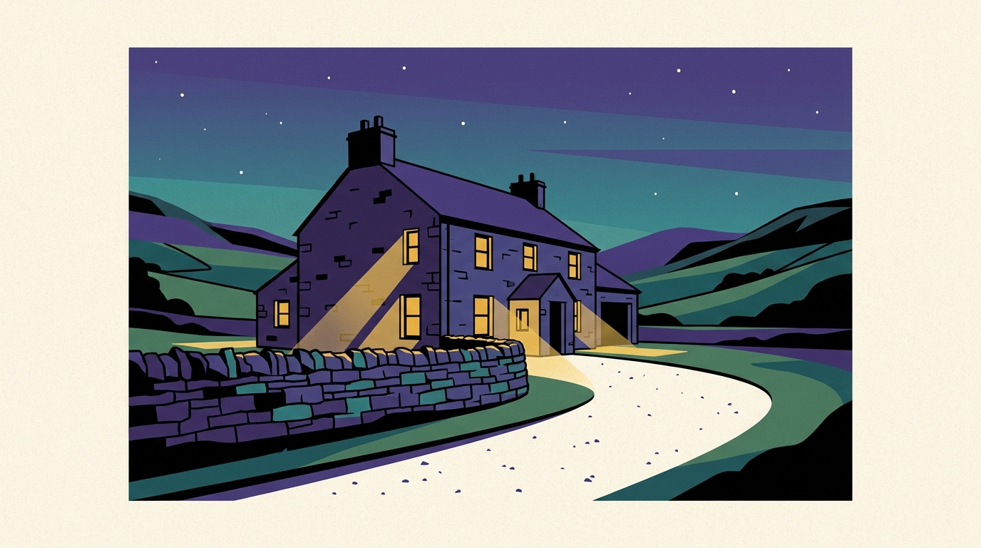 A traditional stone cottage in the Peak District hills at dusk with warm light glowing from the windows.